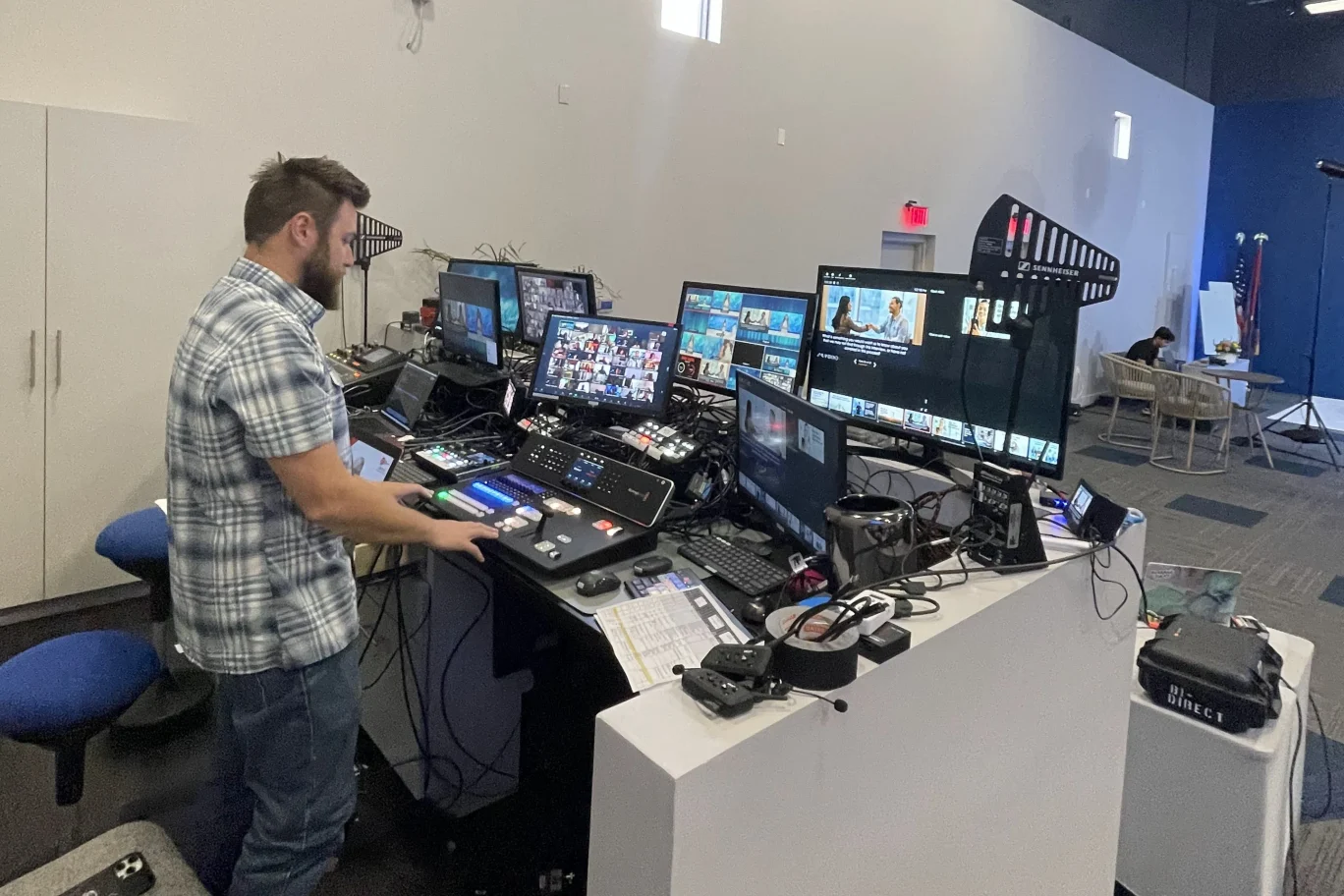 SPRK video operator working with several preview screens at a production desk