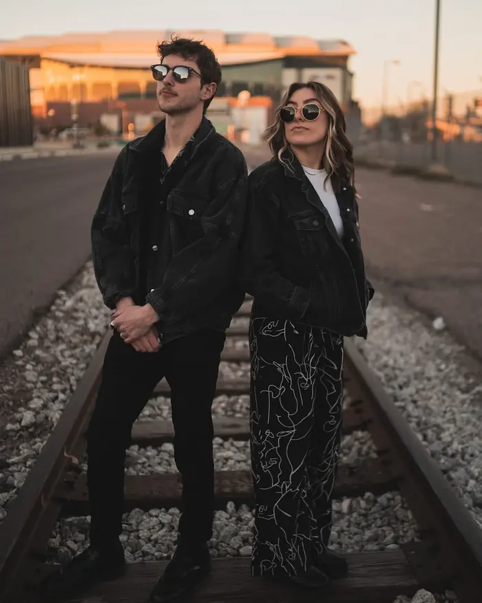 Full-length event portrait of two people photographed outdoors