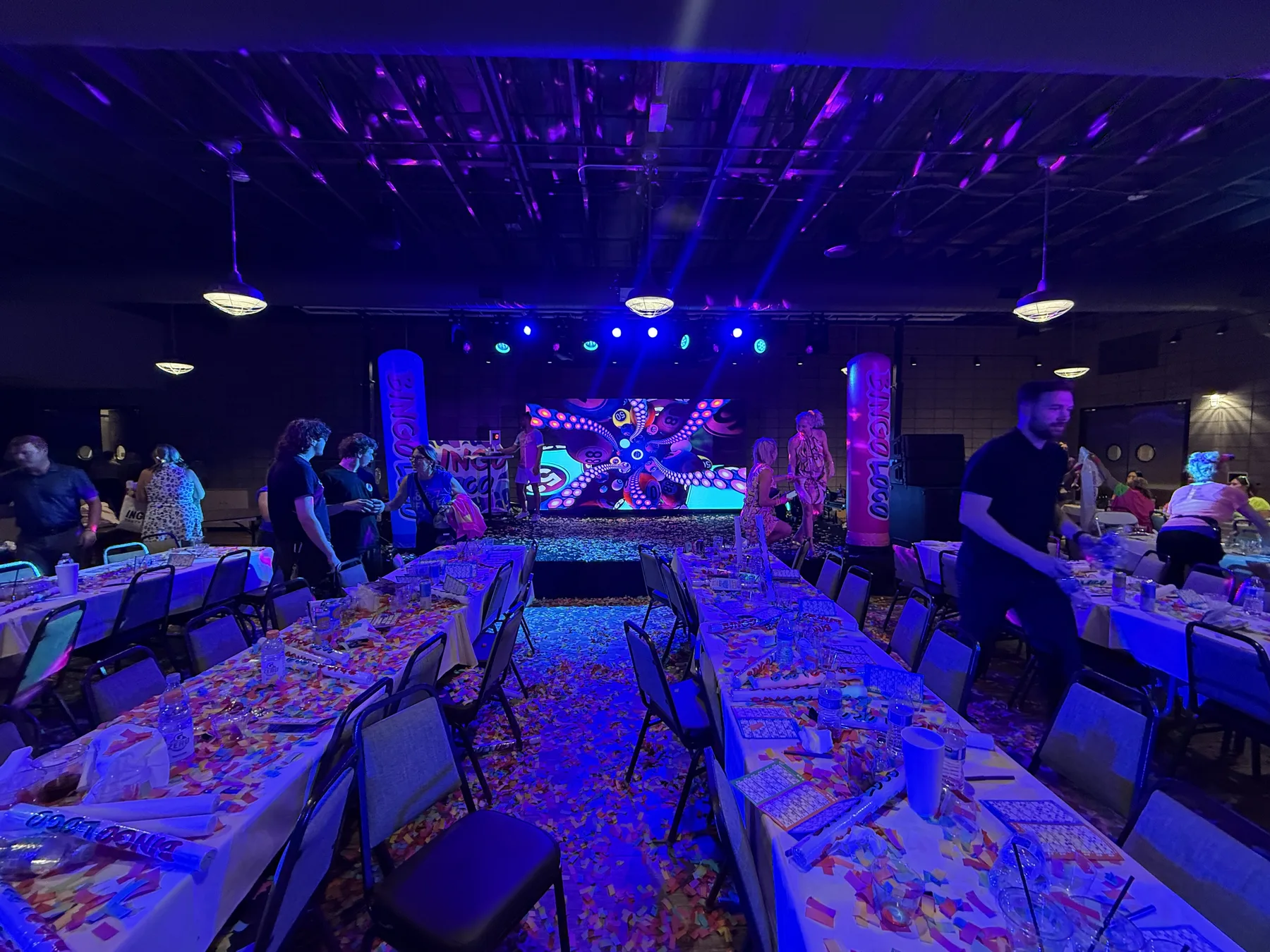 Full event room facing a colorful LED video wall after a live Bingo Loco production